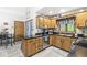 Functional kitchen with wood cabinets, black countertops, and stainless steel appliances at 5948 Ridge Hill Way, Avon, IN 46123