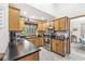 Well-equipped kitchen with wood cabinets, modern appliances, and black countertops at 5948 Ridge Hill Way, Avon, IN 46123