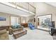 Bright living room with a loft view, featuring comfortable seating and seamless entry to the dining area at 5948 Ridge Hill Way, Avon, IN 46123