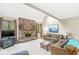 Bright living room featuring a brick fireplace, plush seating, and scenic views at 5948 Ridge Hill Way, Avon, IN 46123