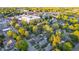 Scenic aerial view showcasing the neighborhood's charming homes, lush trees, and vibrant city center in the distance at 6167 Carrollton Ave, Indianapolis, IN 46220