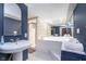Bathroom boasts a vintage sink, bathtub, and glass block shower, creating a retro yet functional space at 6167 Carrollton Ave, Indianapolis, IN 46220