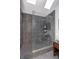 Modern tiled bathroom featuring a glass-enclosed shower with rainfall showerhead and vessel sink at 6167 Carrollton Ave, Indianapolis, IN 46220