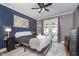 Cozy bedroom with a ceiling fan, patio access, and neutral color palette at 6167 Carrollton Ave, Indianapolis, IN 46220