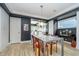 Charming dining room with modern table, contrasting wall paint, and seamless kitchen access at 6167 Carrollton Ave, Indianapolis, IN 46220