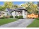 Charming bungalow with a white brick exterior, front porch, and professionally landscaped yard at 6167 Carrollton Ave, Indianapolis, IN 46220