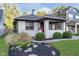 Charming brick bungalow featuring a cozy porch and well-manicured landscaping, perfect for curb appeal at 6167 Carrollton Ave, Indianapolis, IN 46220