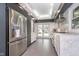 Well-appointed kitchen showcasing modern appliances, elegant marble countertops, and convenient access to the outdoor pool area at 6167 Carrollton Ave, Indianapolis, IN 46220