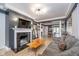 Bright living room with a fireplace, hardwood floors, and an open floor plan at 6167 Carrollton Ave, Indianapolis, IN 46220