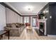 Inviting living room features a cozy couch, fireplace with TV, and an open entryway at 6167 Carrollton Ave, Indianapolis, IN 46220