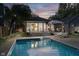 Inviting backyard pool and deck area with lounge chairs and a covered dining space, perfect for outdoor entertaining at 6167 Carrollton Ave, Indianapolis, IN 46220