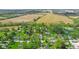 Sprawling landscape featuring homes nestled among trees, bordered by vast open fields at 6191 Geneva St, Stilesville, IN 46180