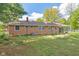 Picture of brick home, complete with a screened-in porch, and a large backyard with lush green lawn at 6191 Geneva St, Stilesville, IN 46180