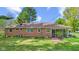 Expansive backyard with mature trees, complemented by a brick home with a screened-in porch at 6191 Geneva St, Stilesville, IN 46180