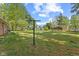 Expansive backyard with lush lawn, mature trees, garden, gazebo, and vintage clothesline at 6191 Geneva St, Stilesville, IN 46180