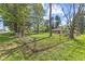 Spacious fenced backyard with mature trees and landscaping offers privacy and room to roam at 6191 Geneva St, Stilesville, IN 46180