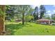 The backyard provides a serene retreat with lots of space, mature trees, and a fire pit at 6191 Geneva St, Stilesville, IN 46180