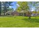 A beautiful backyard features a brick home, a screened-in porch, and well-maintained lawn at 6191 Geneva St, Stilesville, IN 46180