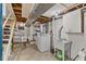 Basement laundry area with washer, utility sink, storage, and exposed ceiling at 6191 Geneva St, Stilesville, IN 46180