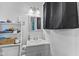 Modern bathroom with gray vanity, chrome faucet, framed mirror, and ample shelving for storage at 6191 Geneva St, Stilesville, IN 46180