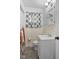 Bathroom featuring tiled walls, toilet, sink and decorative shower curtain at 6191 Geneva St, Stilesville, IN 46180