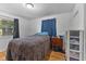 Cozy bedroom features a window, hardwood floors, and a comfortable bed with a striking leopard print comforter at 6191 Geneva St, Stilesville, IN 46180