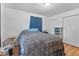 Bright bedroom features hardwood floors, a window, and a bed with a leopard print comforter at 6191 Geneva St, Stilesville, IN 46180