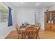 Cozy dining area with wooden table, chairs, and view out a large window at 6191 Geneva St, Stilesville, IN 46180