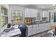 Bright kitchen features white cabinets, dark countertops, and a window view to the backyard at 6191 Geneva St, Stilesville, IN 46180