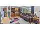 Bright living room featuring hardwood floors and a comfortable leather couch at 6191 Geneva St, Stilesville, IN 46180