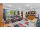 Inviting living room with hardwood floors, a large window, and a comfortable leather couch at 6191 Geneva St, Stilesville, IN 46180