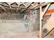 Basement featuring exposed wooden beams, ductwork, and brick, requiring modernization at 623 Orange St, Indianapolis, IN 46203