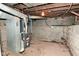 Basement area with a furnace, concrete walls, and exposed pipes and ductwork at 623 Orange St, Indianapolis, IN 46203