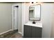 Bathroom features modern vanity, mirror, and luxury vinyl plank flooring at 623 Orange St, Indianapolis, IN 46203