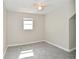 Bright bedroom showcasing a ceiling fan, neutral paint, and a window offering ample natural light at 623 Orange St, Indianapolis, IN 46203