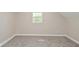 Cozy bedroom featuring neutral paint, carpeted floors, and a window providing natural light at 623 Orange St, Indianapolis, IN 46203
