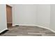 Bedroom with neutral walls, large base trim, and wood look luxury vinyl plank flooring at 623 Orange St, Indianapolis, IN 46203