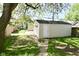 Detached one-car garage in backyard with greenery, accessed by a concrete walkway at 623 Orange St, Indianapolis, IN 46203