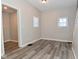 Well-lit living room featuring a large window and wood-look flooring at 623 Orange St, Indianapolis, IN 46203