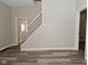 Open-concept living room with stairwell and durable flooring at 623 Orange St, Indianapolis, IN 46203