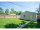 Spacious backyard featuring a grassy lawn, wooden fence, and detached garage at 625 Dequincy St, Indianapolis, IN 46201