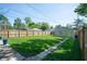 Spacious backyard featuring a grassy lawn, wooden fence, and detached garage at 625 Dequincy St, Indianapolis, IN 46201