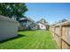 Expansive backyard featuring a grassy lawn, wooden fence, and mature trees at 625 Dequincy St, Indianapolis, IN 46201