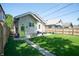 Lovely backyard featuring a grassy lawn, detached garage, and patio area at 625 Dequincy St, Indianapolis, IN 46201