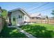 Lovely backyard featuring a grassy lawn, detached garage, and patio area at 625 Dequincy St, Indianapolis, IN 46201