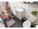 Modern bathroom featuring a white vanity, patterned shower curtain, and black hexagonal tile flooring at 625 Dequincy St, Indianapolis, IN 46201