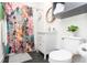 Well-lit bathroom featuring a white vanity, patterned shower curtain, and black hexagonal tile flooring at 625 Dequincy St, Indianapolis, IN 46201