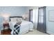 Comfortable bedroom featuring a queen bed, soft white bedding, and large windows at 625 Dequincy St, Indianapolis, IN 46201