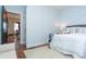 Bright bedroom featuring a queen bed with white bedding and natural light from an open doorway at 625 Dequincy St, Indianapolis, IN 46201