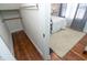 Hallway leading into a bedroom featuring a queen bed with white bedding and light-colored carpet at 625 Dequincy St, Indianapolis, IN 46201